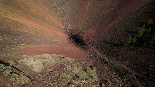 Tourists at the Deep and Wide Crater of a Volcano