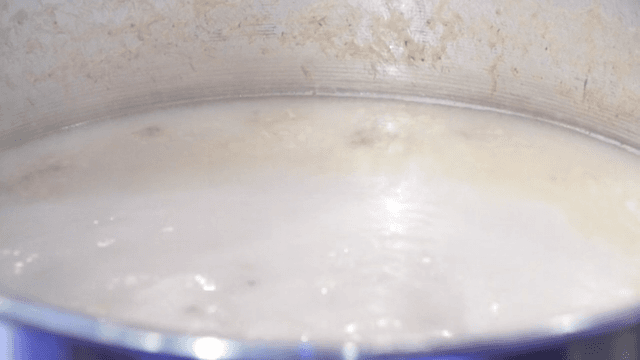 Beef leg bone broth boiling in a large pot