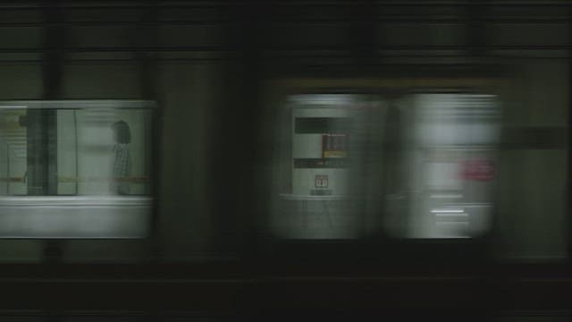 Person standing on empty subway platform in city