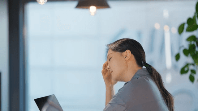 Woman working on a laptop in an office