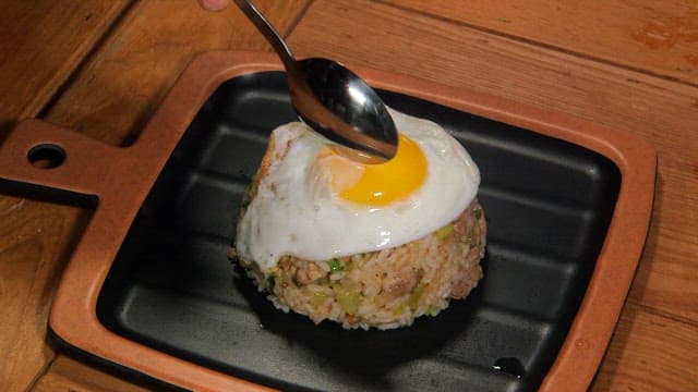 Fried rice topped with a sunny-side-up egg