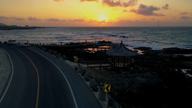 Sunset Beach Road and Sea with Rough Waves