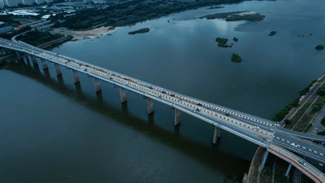 Bridge over a river with cars passing by