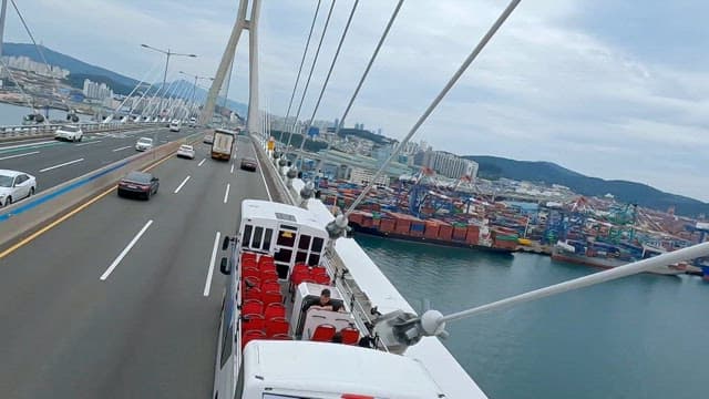 Double-decker tourist bus passing Gwangandaegyo Bridge
