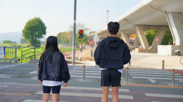 People warming up while waiting at the crosswalk