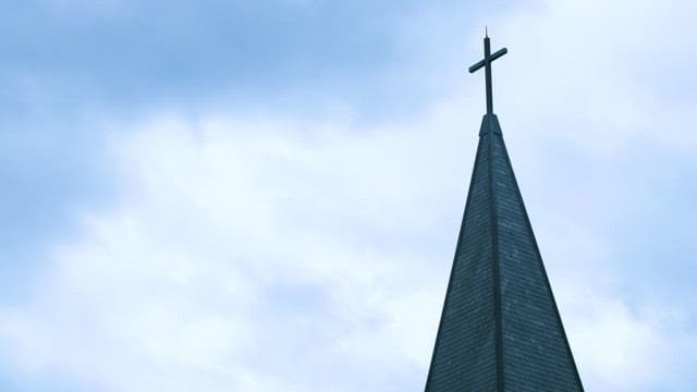 Church steeple against a cloudy sky