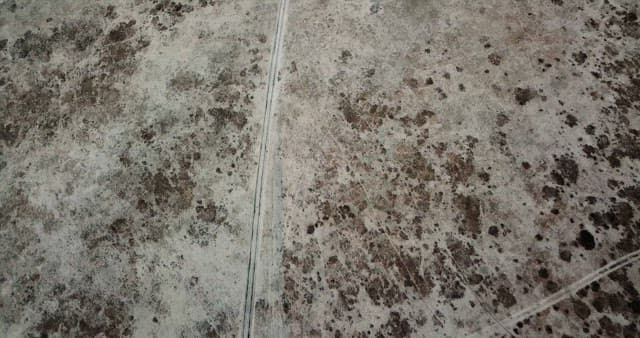 Snow-covered mountains and barren land