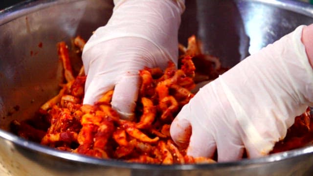 Mixing raw pollack seasoning with red pepper powder