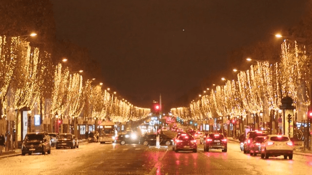 Nighttime city street decorated with festive lights