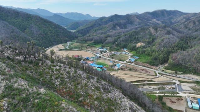 Rural village nestled in lush green mountains and farmlands
