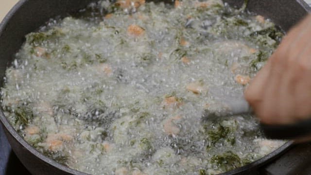 Vegetables fried in a frying pan with oil