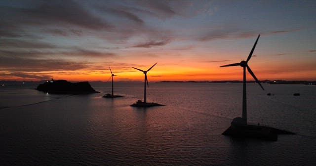 Wind Turbines at Sea During Sunset