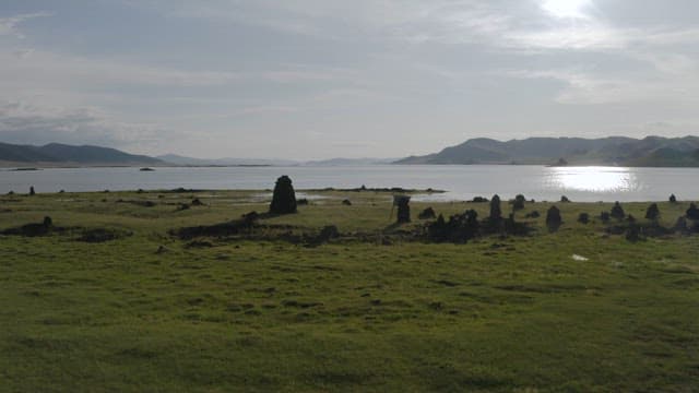 Sunshine Serene Lakeside View with Distant Mountains