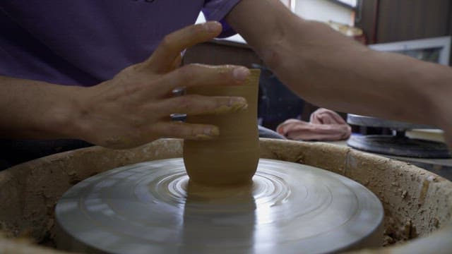 Pottery clay being formed on a pottery wheel