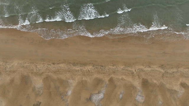 Waves gently hitting a sandy beach