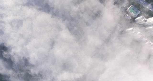 Landscape with buildings and roads under clouds