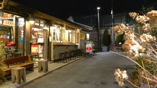 Cozy cafe in an alleyway at night with the lights on