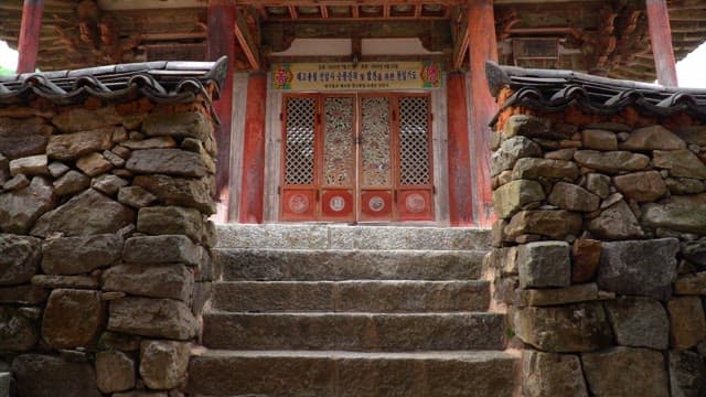 Entrance of a Seonamsa Temple with decorative wooden doors and stone steps