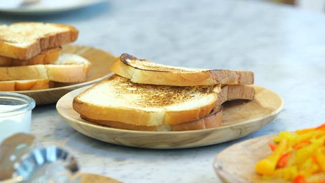 Breakfast table with fried bell pepper and grilled toast
