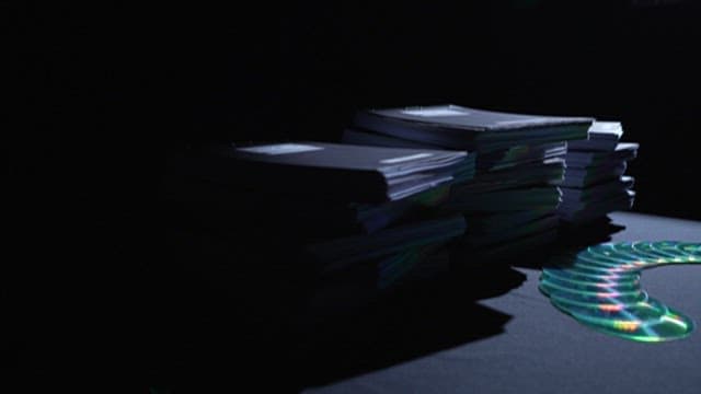 Stacks of Documents and Discs in Dim Light