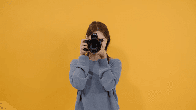 Woman taking pictures with a DSLR camera