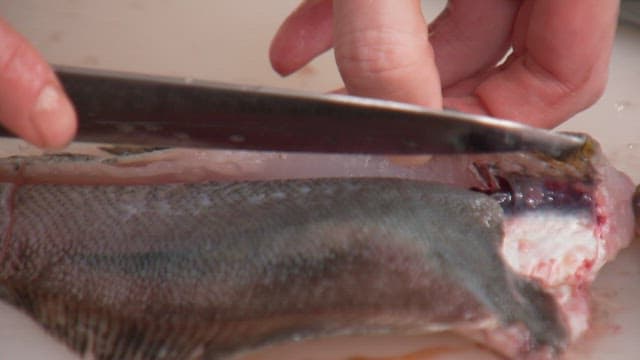 Delicately filleting a fresh fish in the kitchen with a knife