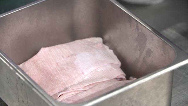 Black secret sauce poured over pork rinds