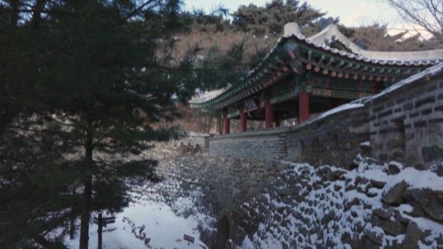 Snow-covered Traditional Korean Pavilion in Forest