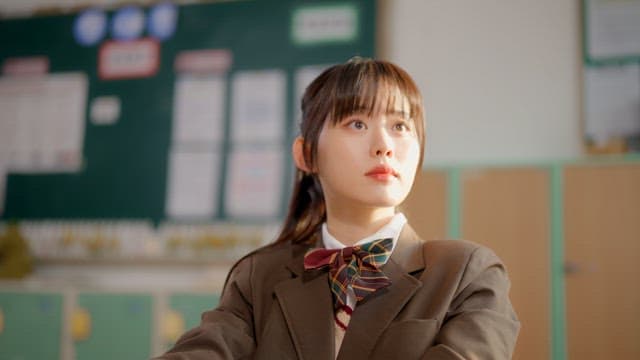 Student in a classroom looking thoughtful