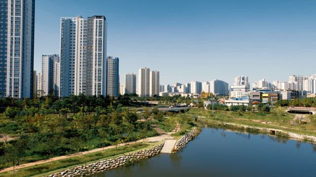 Landscape with high-rise apartments and river on a sunny day