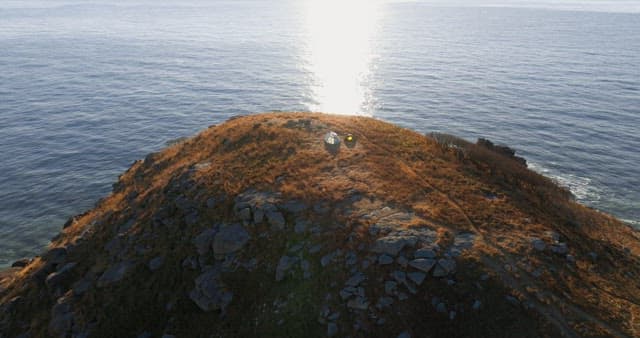 Seaside Hilltop with Hikers and Tents