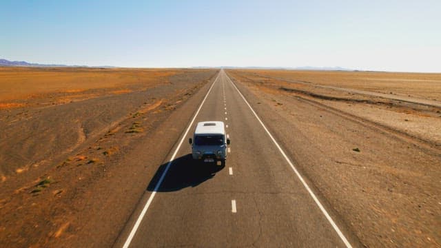 Van Traveling Down the Open Desert Road