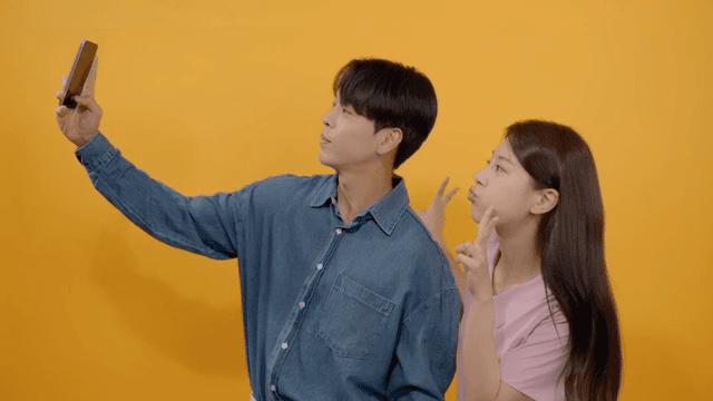 Man and a woman taking intimate selfies in various poses