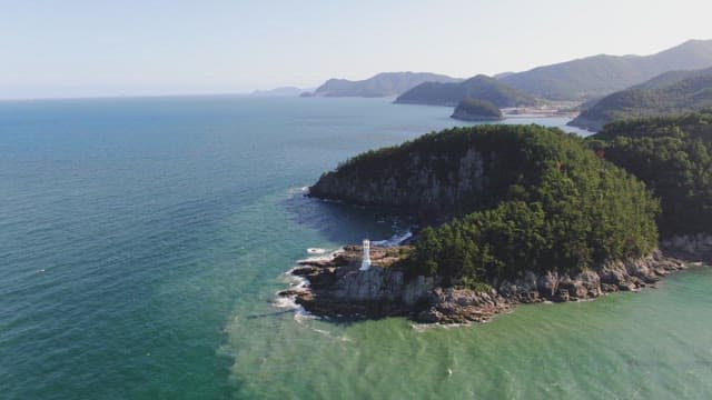 Scenic island with a lighthouse and ocean