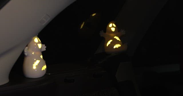 Inside a car with lit Halloween decorations
