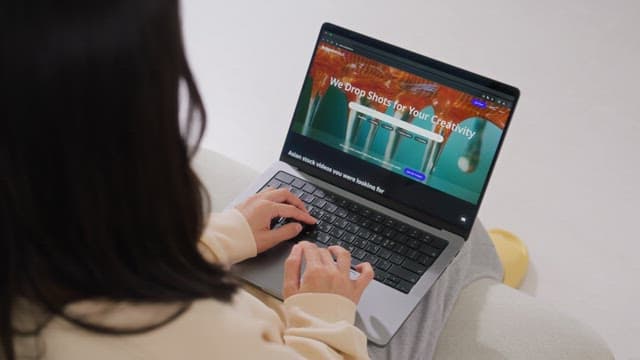 Woman browsing the internet on a laptop