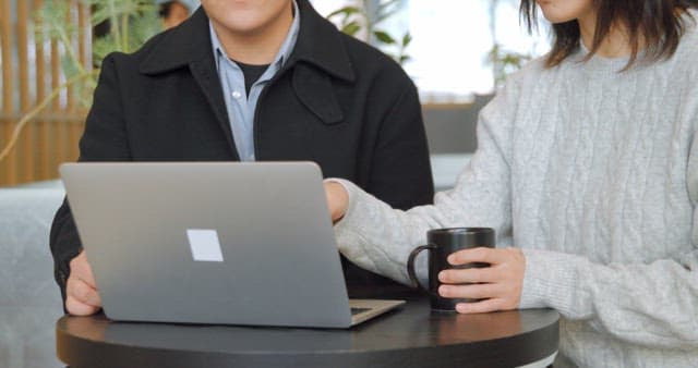 Colleagues Collaborating with Laptop