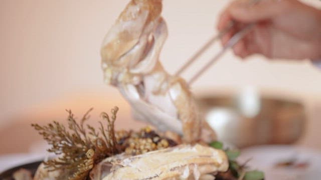 Picking up a Big Chicken Leg from Samgyetang and Putting it in a Bowl