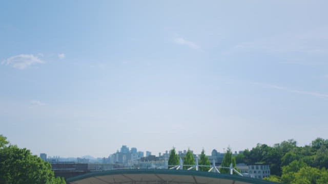 People sitting on the stage of an outdoor amphitheater between recordings