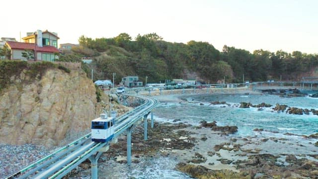 Monorail running along the rocky coastline