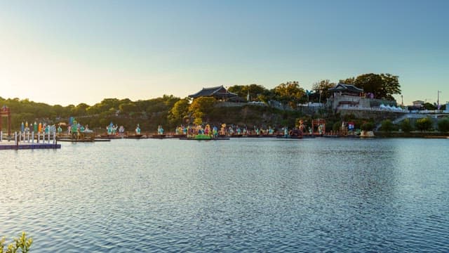 Colorful lanterns floating on the river below Jinjuseong Fortress