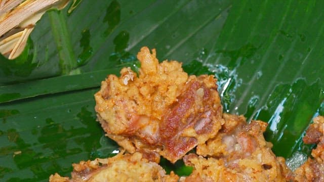 Crispy fried chicken on a banana leaf