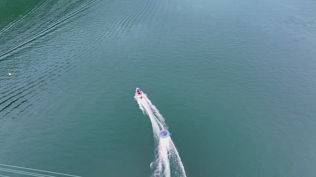 People enjoying a banana boat ride on a river