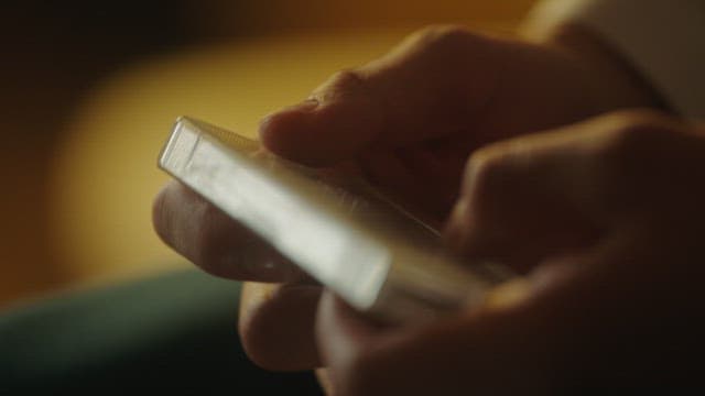Close-up of hands using a cassette and player