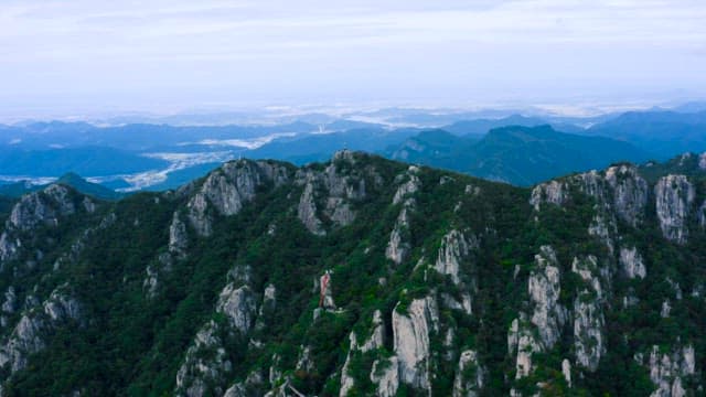 Majestic Mountain Ranges Under A Cloudy Sky