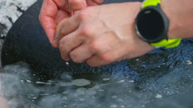 Cracking an megapode egg into a hot pan