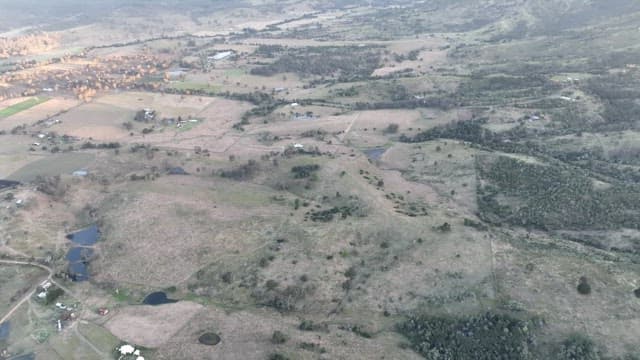 Aerial view of a rural landscape with mountains