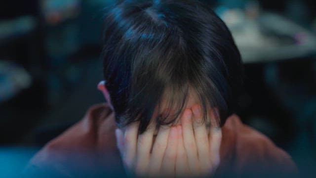Person Deep in Thought While Looking at a Screen in a PC room