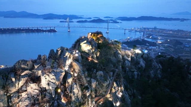 Scenic view of a mountain and bridge at dusk
