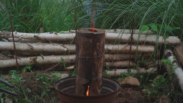 Firewood burning in a metal barrel